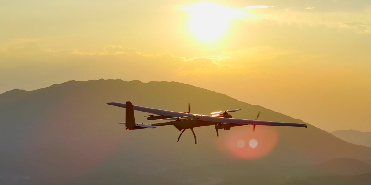 VTOL tilt-rotor drone in fixed-wing flight mode for long-range infrastructure monitoring